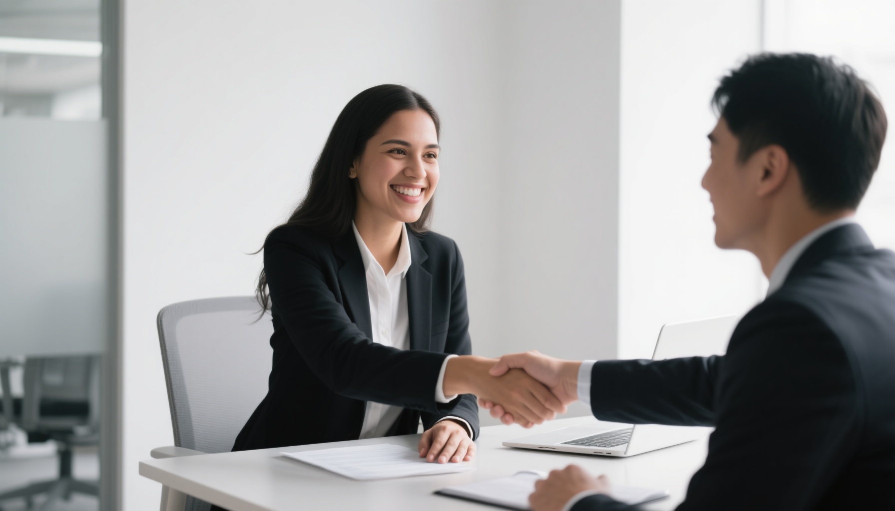 Professional handshake between interviewer and candidate